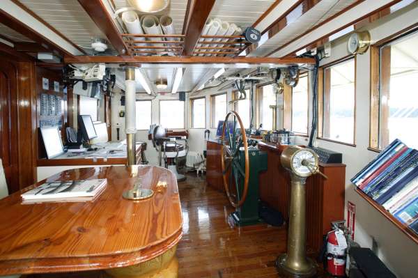 Wheelhouse with Forward View. Guest seating to the left at the table.